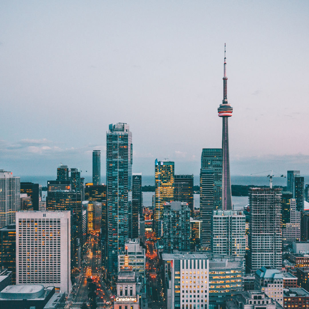 Aerial view of the Toronto skyline, showcasing iconic buildings against a clear sky in Canada